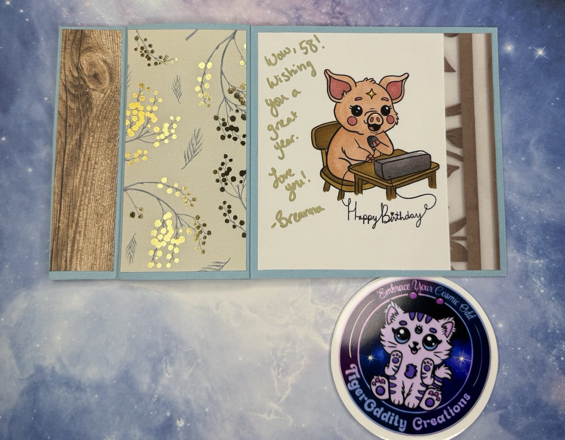 Funny handmade card for dad is a book bind Z-fold card featuring a custom digital stamp of a cartoon pig (ham) operating a ham (amateur) radio station. The pig is seated at a desk with a microphone and radio unit. The front of the card reads “Ham It Up (for your birthday)” in bold text. Inside is a handwritten birthday message. Card is colored with Ohuhu alcohol markers and uses patterned paper from craft stash.